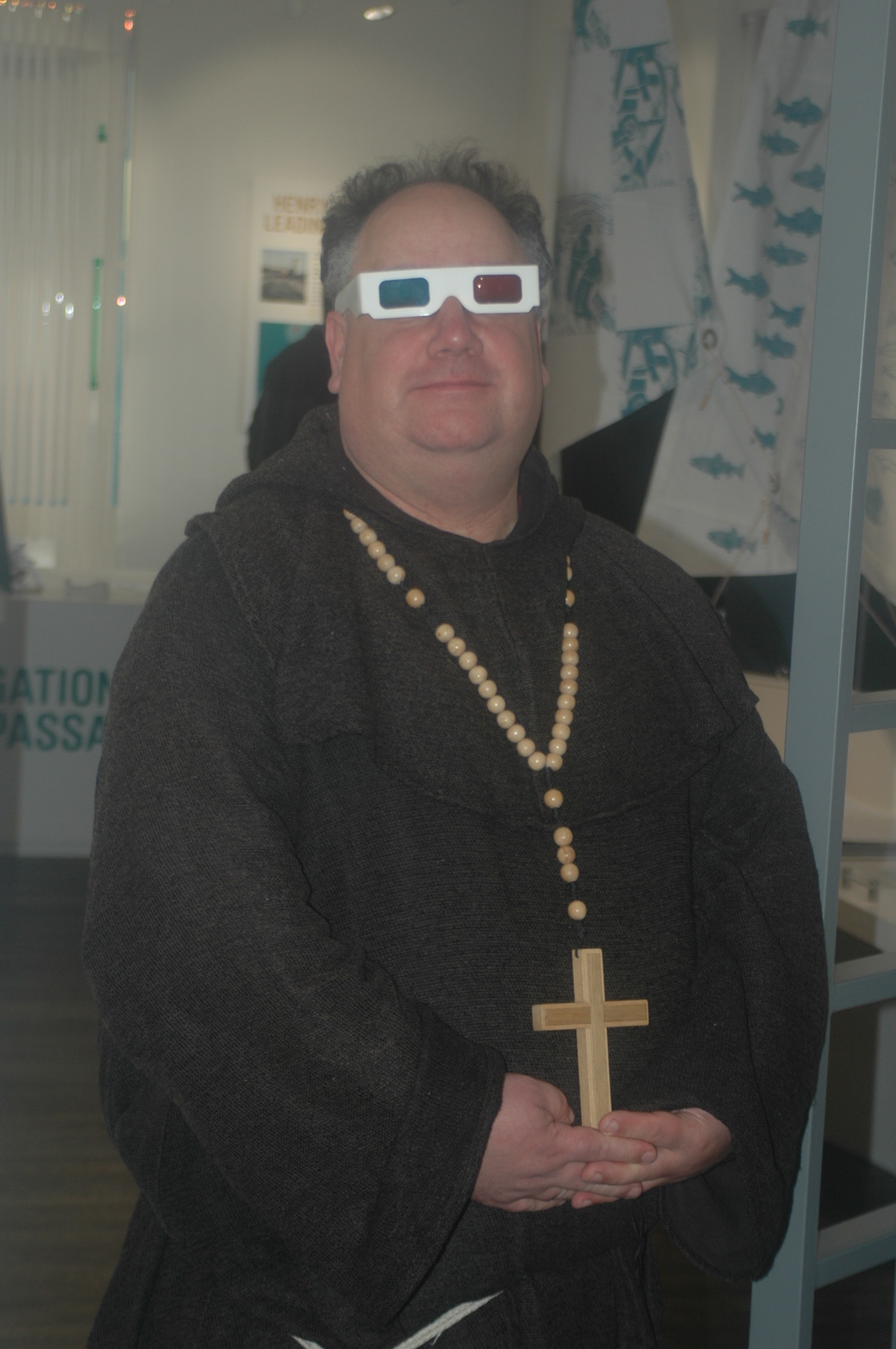 re-enactor dressed as mediaeval monk, wearing anaglypd 3D glasses